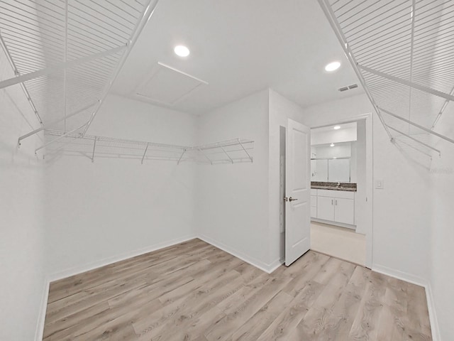 spacious closet featuring light wood-type flooring