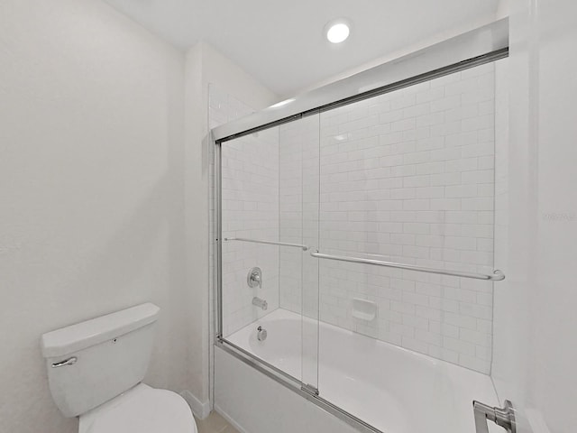 bathroom with enclosed tub / shower combo and toilet