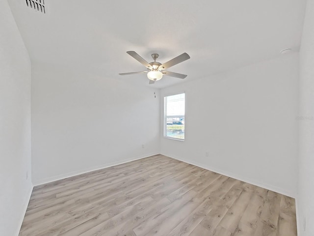 spare room with ceiling fan and light hardwood / wood-style flooring