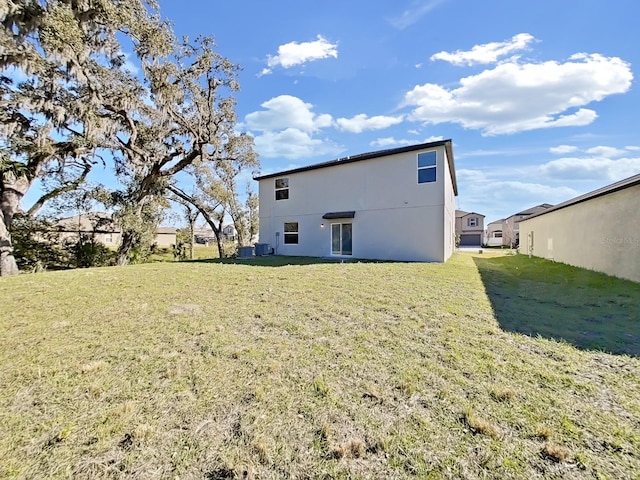 back of property with a lawn