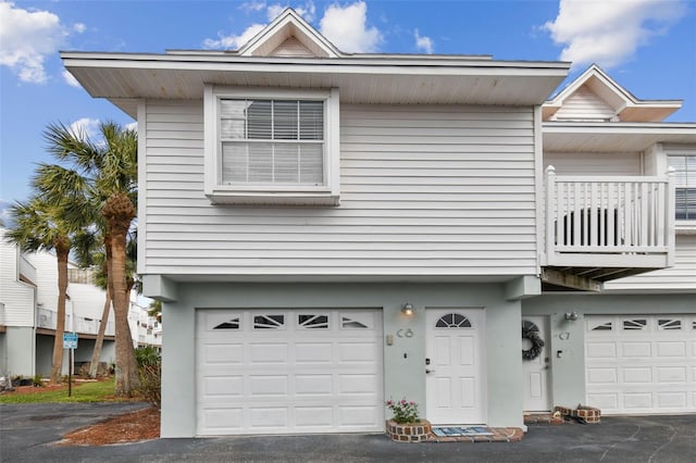 exterior space with a balcony and a garage