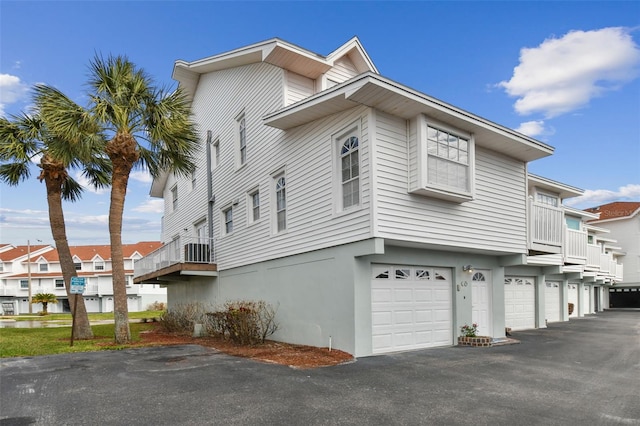 view of property exterior with a garage and cooling unit