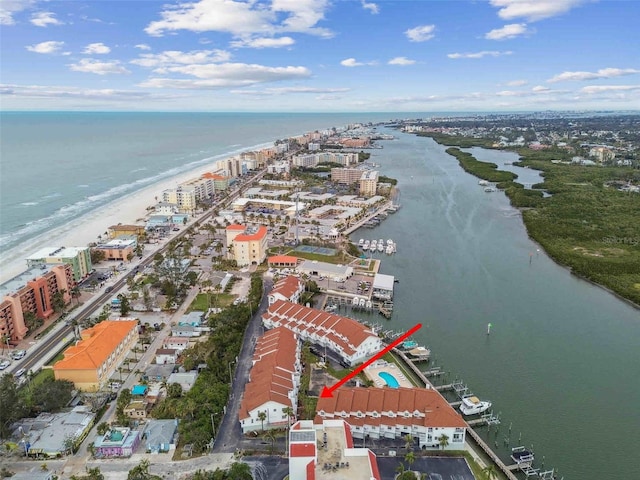 drone / aerial view with a water view and a beach view