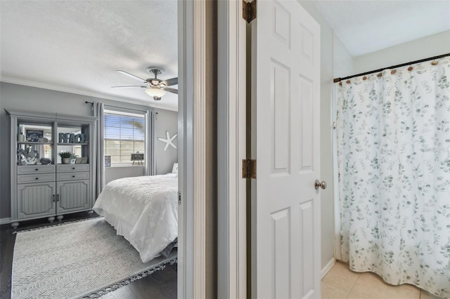 tiled bedroom with ceiling fan