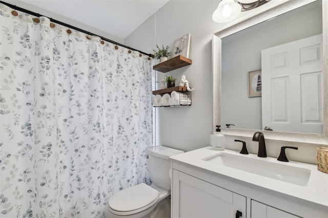 bathroom with a shower with shower curtain, vanity, and toilet