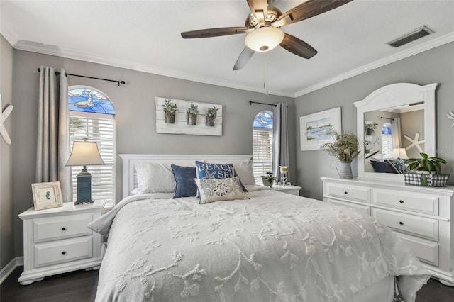 bedroom featuring ornamental molding, ceiling fan, and dark wood-type flooring