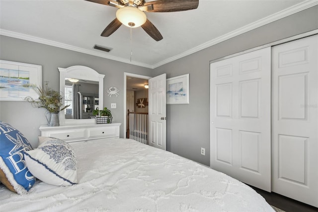 bedroom featuring a closet, ceiling fan, and crown molding