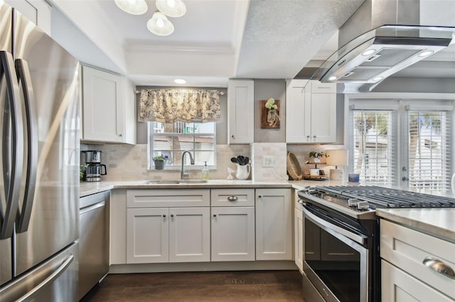 kitchen with sink, light stone counters, extractor fan, white cabinets, and appliances with stainless steel finishes