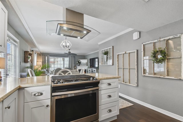 kitchen featuring ceiling fan, white cabinetry, a textured ceiling, and stainless steel range