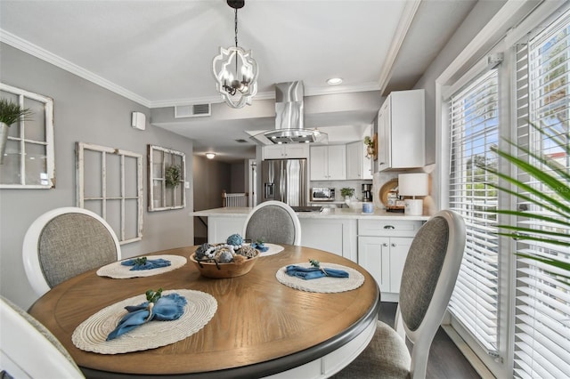 dining space featuring ornamental molding and an inviting chandelier