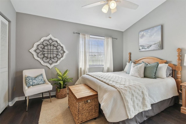 bedroom with a closet, vaulted ceiling, ceiling fan, and dark wood-type flooring