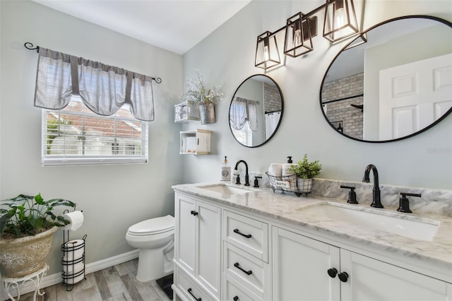 bathroom with hardwood / wood-style flooring, vanity, toilet, and walk in shower