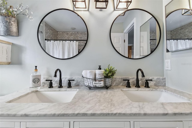 bathroom featuring vanity and curtained shower