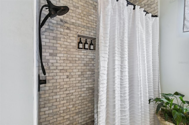 bathroom featuring brick wall