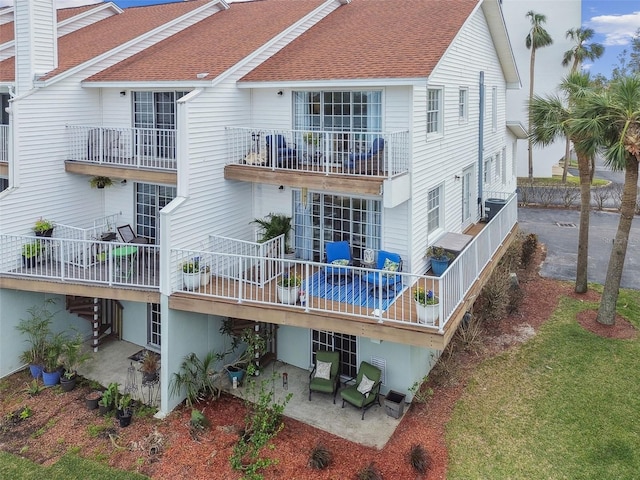 rear view of property with a patio and cooling unit