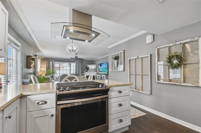 kitchen with ceiling fan, stainless steel range, white cabinets, and a textured ceiling