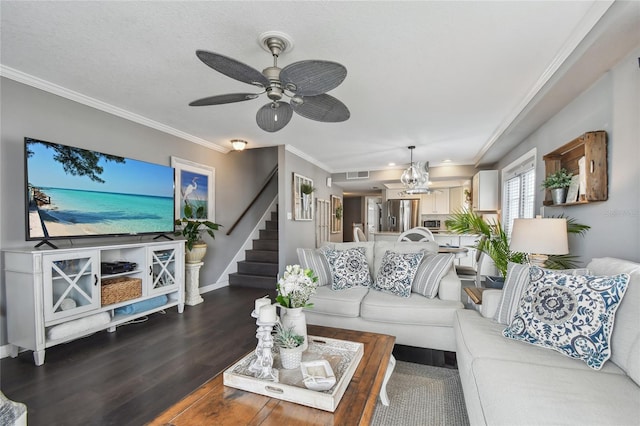 living room featuring a textured ceiling, crown molding, dark hardwood / wood-style flooring, and ceiling fan with notable chandelier