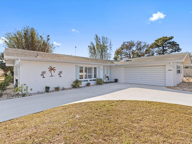 ranch-style house with a garage and a front yard