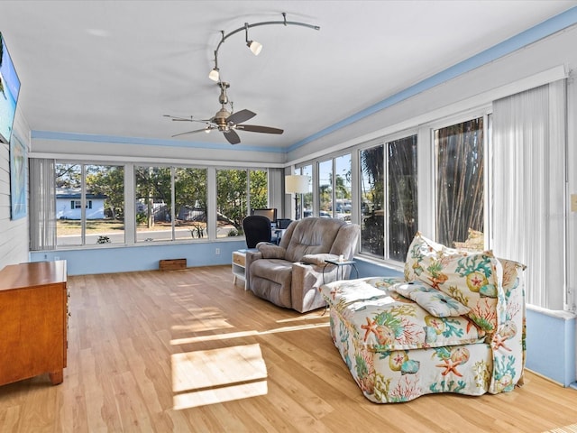 sunroom / solarium featuring ceiling fan