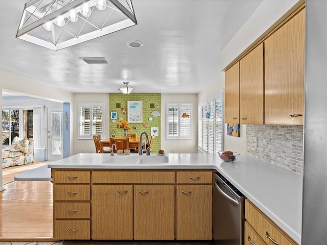 kitchen featuring kitchen peninsula, a wealth of natural light, and sink