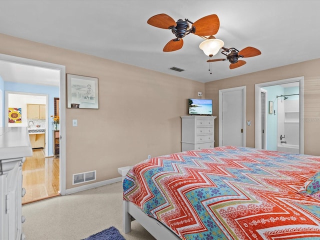 bedroom featuring connected bathroom and ceiling fan