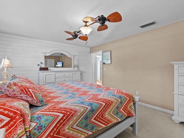 bedroom with ceiling fan and light carpet