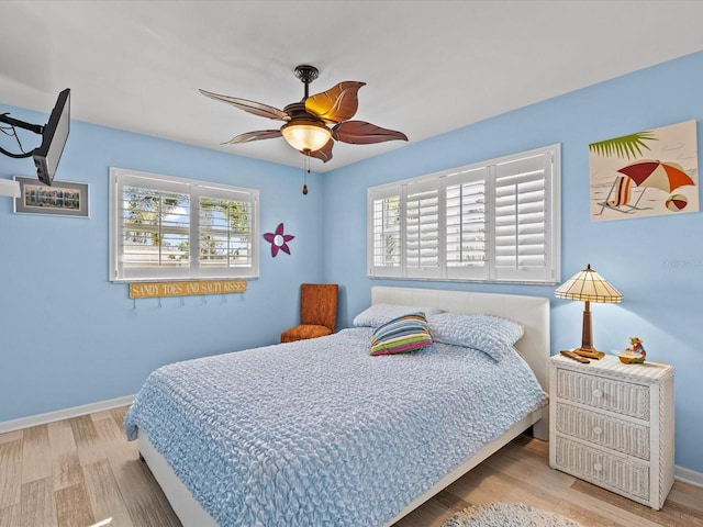 bedroom featuring hardwood / wood-style flooring and ceiling fan