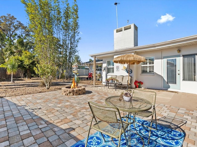 view of patio with an outdoor fire pit