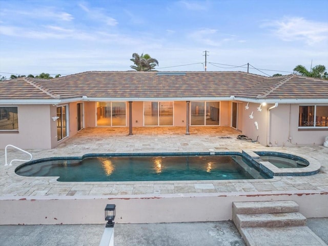 view of pool with an in ground hot tub and a patio