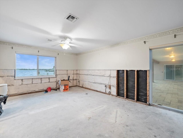 interior space featuring ceiling fan and a water view