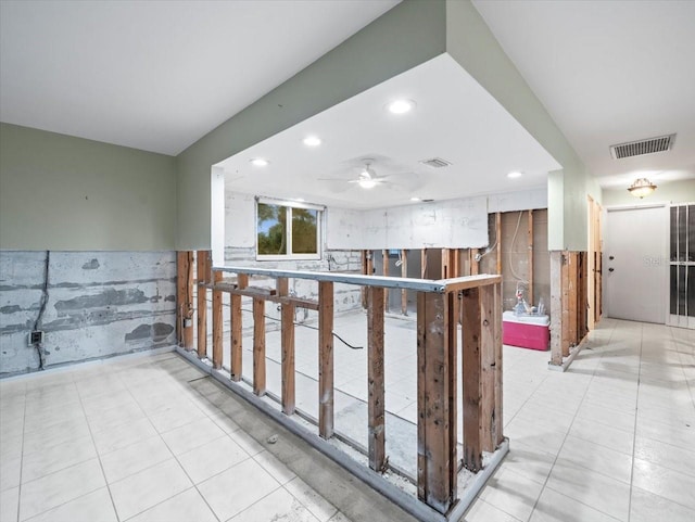 interior space featuring ceiling fan and white cabinetry