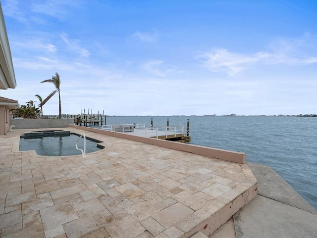 view of swimming pool with a boat dock and a water view