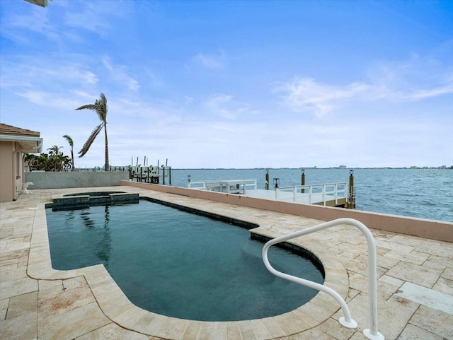 view of swimming pool with a water view and an in ground hot tub