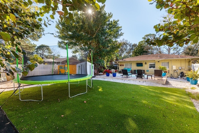 view of yard featuring a patio area, a storage shed, and a trampoline