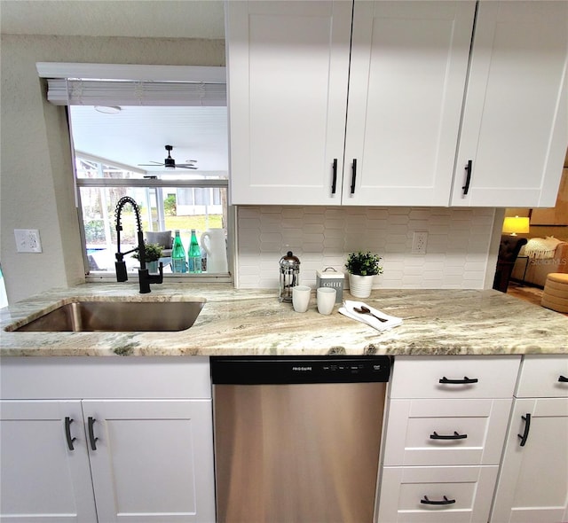 kitchen with a sink, white cabinets, and stainless steel dishwasher