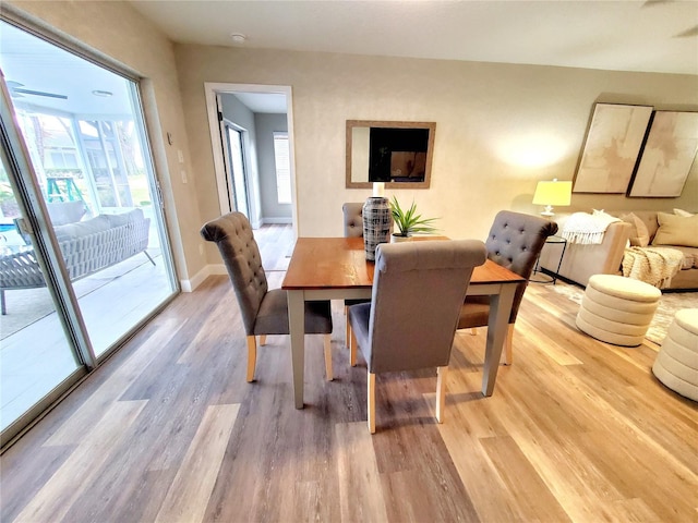 dining room with light wood-type flooring and baseboards