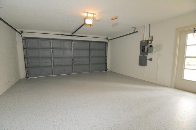 garage with electric panel and a garage door opener