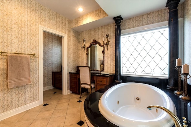 bathroom with vanity, a wealth of natural light, tile patterned flooring, and a relaxing tiled tub