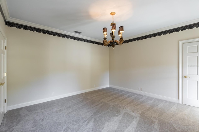 carpeted empty room featuring ornamental molding and an inviting chandelier