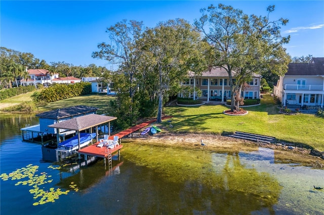 dock area with a yard and a water view