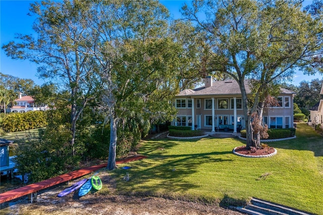 back of house featuring a yard