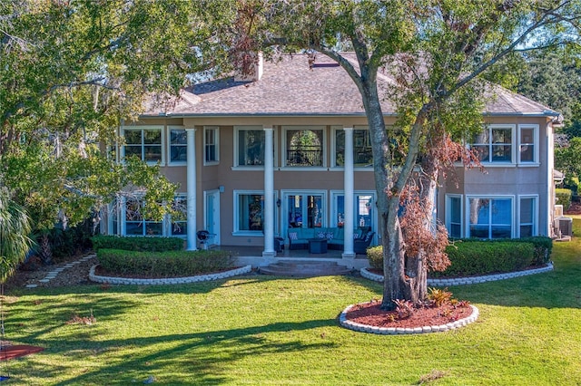 view of front of house featuring a front yard and cooling unit