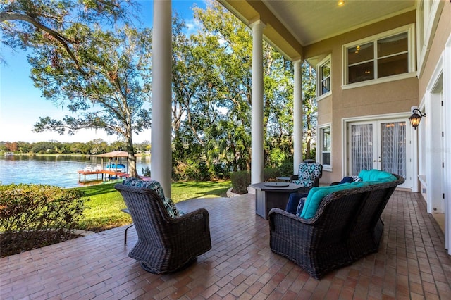 view of patio featuring an outdoor living space and a water view