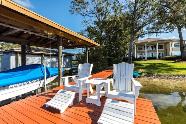 dock area featuring a yard and a water view