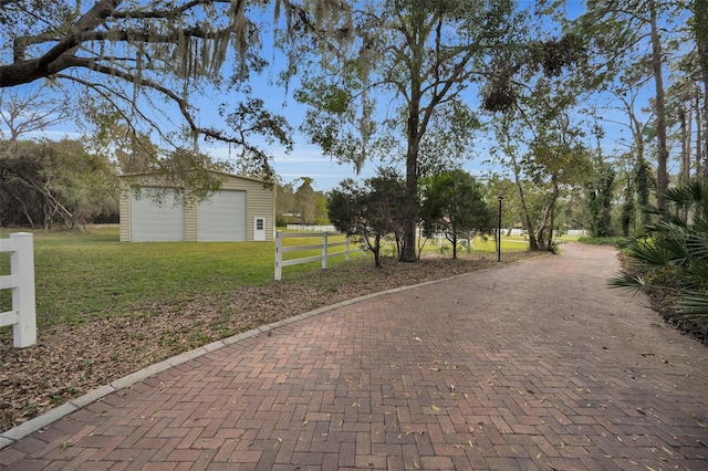 view of home's community featuring a lawn and an outdoor structure