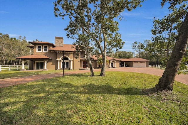 view of front of house featuring a front yard and a garage