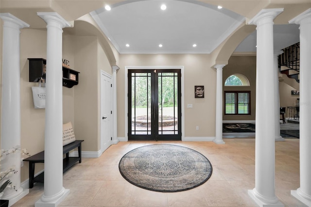 entrance foyer featuring light tile patterned flooring, ornamental molding, and french doors