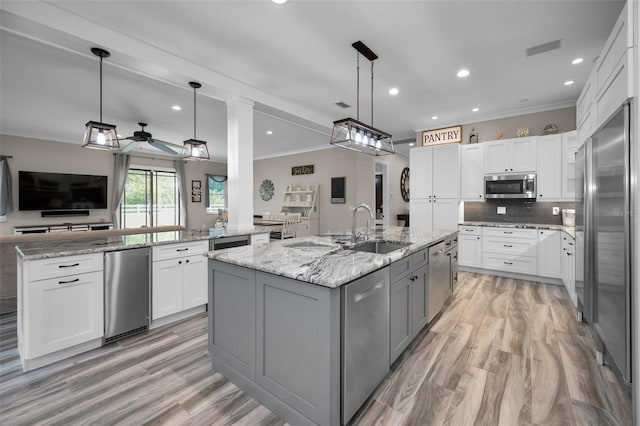 kitchen featuring appliances with stainless steel finishes, white cabinetry, and a large island