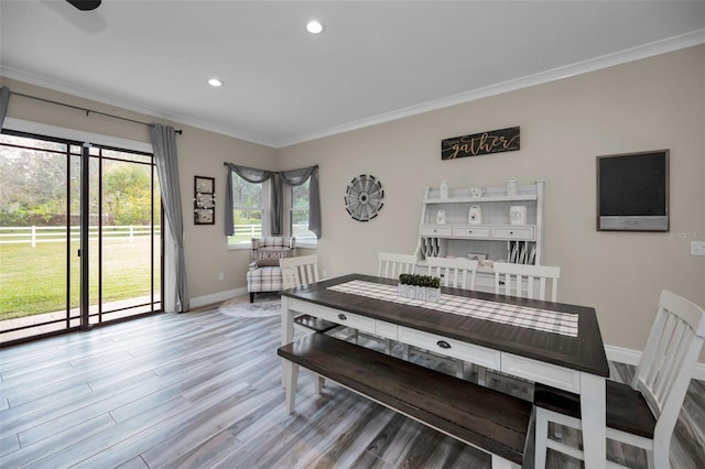 dining room featuring light hardwood / wood-style flooring and ornamental molding