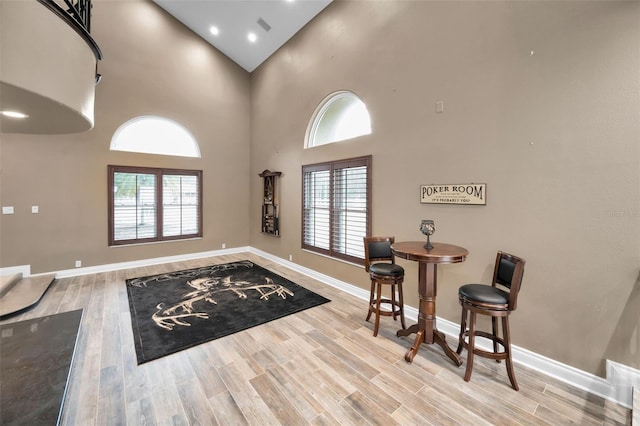 foyer entrance featuring light wood-type flooring and a high ceiling